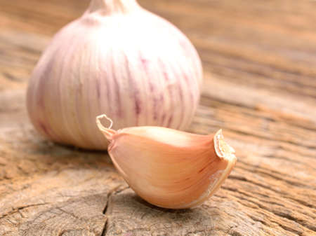 Garlic on a old wooden backgroundの写真素材