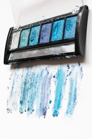 Blue eyeshadow trail with a little mirror on a white backgroundの写真素材