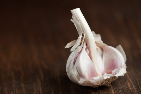 Garlic bulb resting on wood