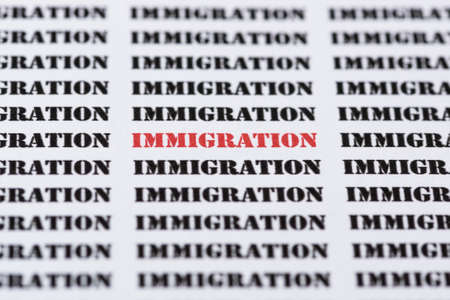 The word IMMIGRATION highlighted in red amongst similar black textの写真素材