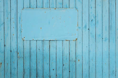 Blank blue sign on blue painted timber board の写真素材