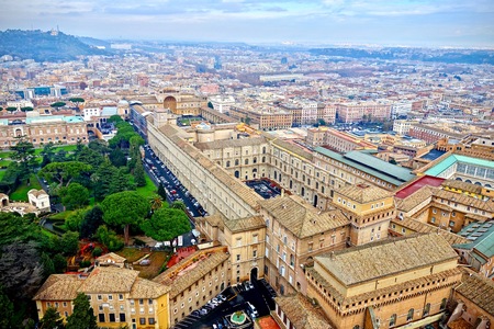From the Petersdom an aerial view of the rooftops of Rome and Vatican Park, Italy in a travel and tourism conceptのeditorial素材