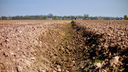 arable land from low angle and village in the background