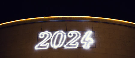 Illuminated neon sign of the new year 2024 on a buildingの写真素材