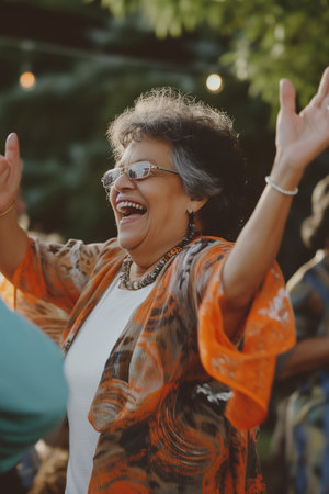 Senior woman in glasses dancing at a partyの素材