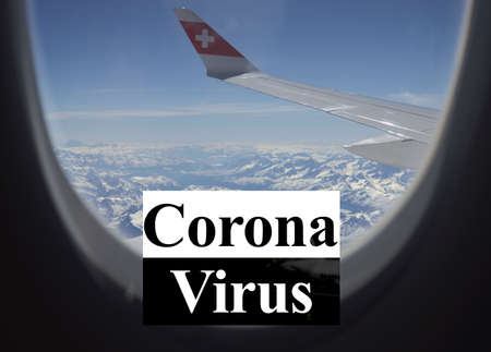 Zuerich, March 2020: Coronavirus cancelling of flights to stop spreading of the pandemic. Through airplane window above mountains in swiss airpaneのeditorial素材
