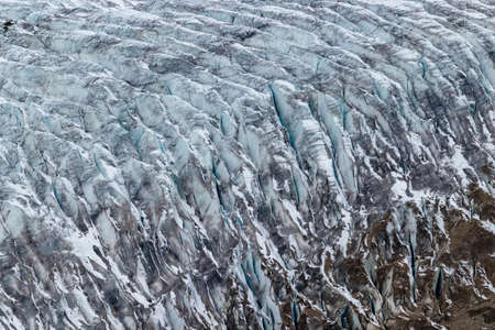 Glacier texture close up with cracks and dirt on surface.の写真素材