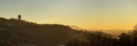 Panoramic Viewing tower above autumn forest with orange sunset.の写真素材