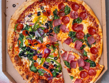Pizza in take away cardboard box close up.の写真素材