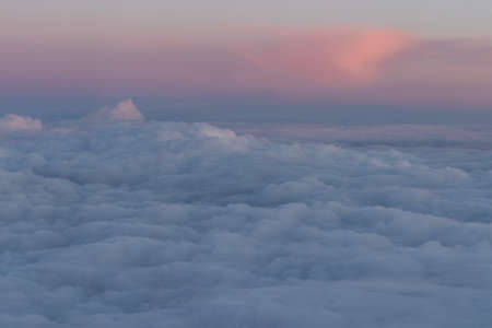 Clouds seen from above out of airplane at sunset.の写真素材