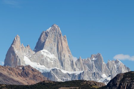 Mount Fitz Roy also known as Cerro Chalten, Cerro Fitz Roy, or Monte Fitz Roy close up on a sunny day with blue sky. It is a mountain in Patagonia, on the border between Argentina and Chileの写真素材