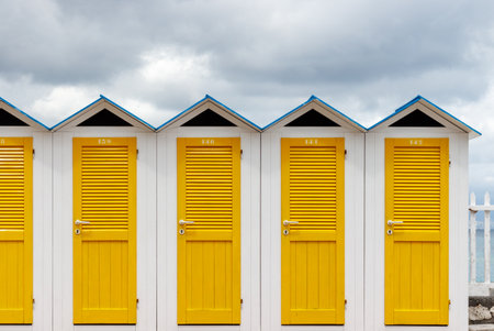 Vintage little beach house or cabins with yellow doors in a rowの写真素材