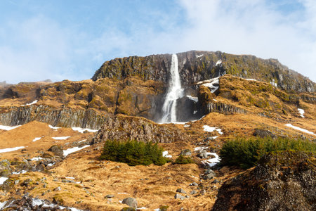 bjarnafoss waterfall on snaefellsnes peninsula in iceland on a sunny cloudy dayの写真素材
