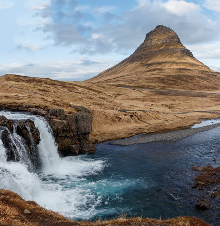 Kirkjufell and waterfall on the coast of Snaefellsnes peninsula on a cloudy day. Famous place Kirkjufellsfoss waterfall, Iceland, Europe, travel. Beauty world.の写真素材