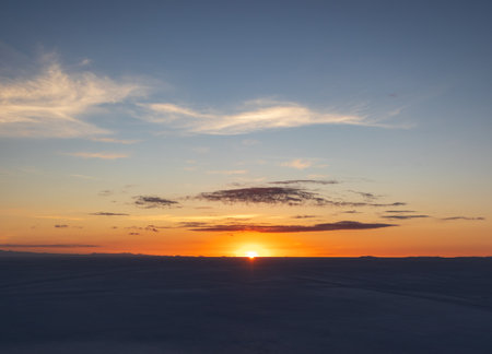 Sunrise above vast salt flat in Salar de Uyuni, Boliviaの写真素材