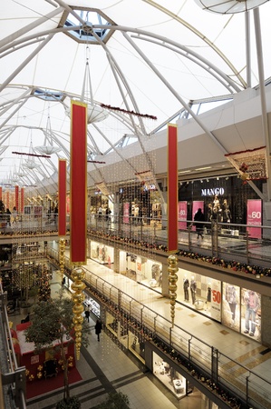 Istanbul, Turkey - January 3, 2011: Interior of a shopping mall during Christmas. Lots of people walking around going to stores, buying things and consuming food and beverages.のeditorial素材