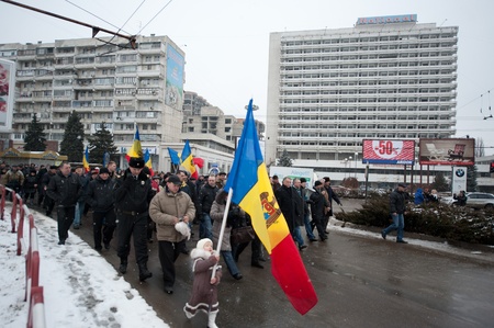 Holding a Moldovan flag, young Nastya marches in Chisinau, Moldova, at a protest against current administration.のeditorial素材