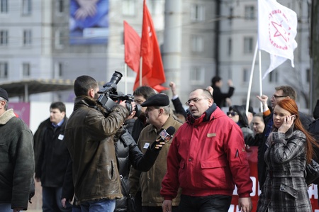 Alexander Petkov, deputy from the Communist Party giving an interview to the pro communist tv station NIT during the march of 10 thousand people during the march of against the current administration and president elections. Chisinau, Republic of Moldova.のeditorial素材