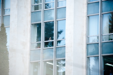 Women speaking on the phone in the government building of Moldova, as the communist protests against the current administration and president elections in the National Square.のeditorial素材