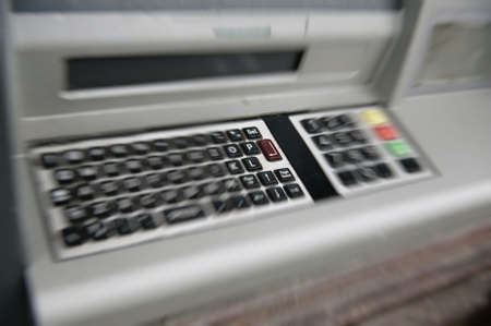 ATM (automated teller machine) dirty QWERTY keyboard with focus on Enter button.の写真素材