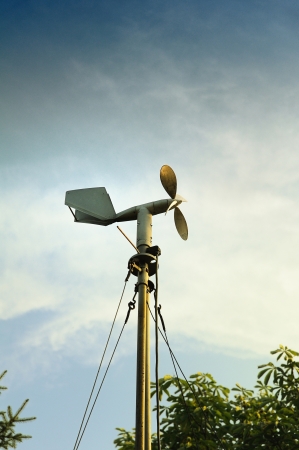 A windmill style of anemometer - such weather monitoring devices as tje anemometer was developed in 1926 and remains widely used for the wind speed measurements  Useful file for your brochure about weather, ecology and other media needsの写真素材