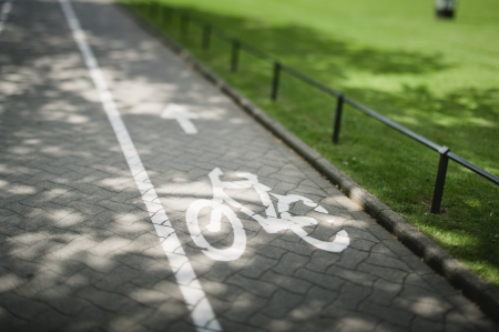 Sign on bike lane. Tilt shift lens used to accent the bike and to emphasize the attention on it.の写真素材