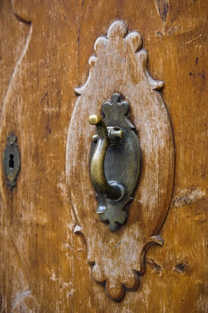 An old metal door-handle knocker on an medieval doorの写真素材