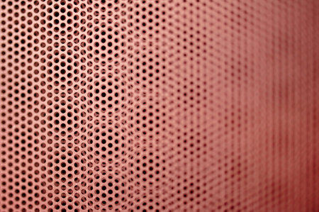 Abstract red metal grill seamless pattern with shallow depth of field. Tilt-shift lens used to accent the specific pattern and to emphasize the attention on it.の写真素材