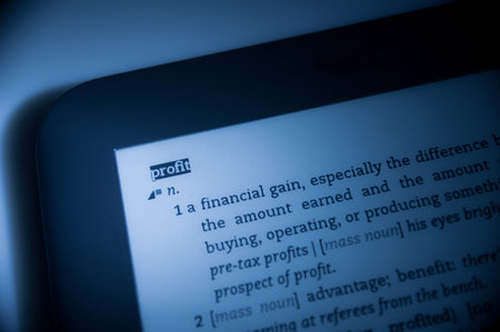 Definition of word "profit" in dictionary in a blue color cast with tilt-shift lens used.の写真素材