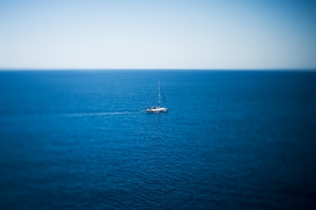 Luxury yacht sailing in tropical calm sea  Tilt-shift lens used to accent the boat and to emphasize the attention on it in comparation with the large seaの写真素材