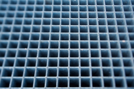 Blue metal grill floor  Tilt-shift lens used to accent the center of the steel and to emphasize the attention on it の写真素材