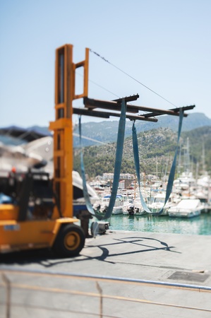 Forklift used as a yacht crane in a luxury harborの写真素材