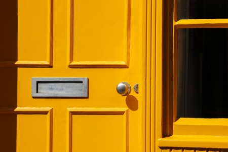 Wooden front door  doorway  in Traditional Georgian architecture freshly painted in yellow color の写真素材