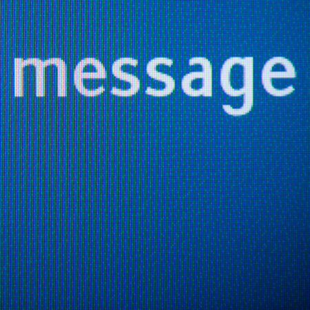Message word on a digital pixelated display. Close-up with large copy space.の写真素材