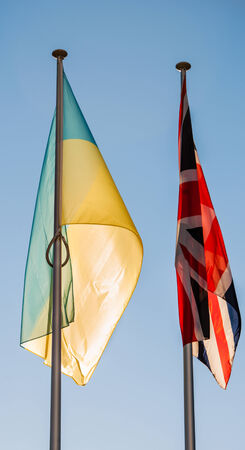 Flags of the Ukraine and United Kingdom on a blue clear sky in front of the Council of Europe, Strasbourg -  Franceの写真素材