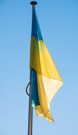 Flying Ukraine flag on a blue clear sky in Strasbourg, France - in front of the Council of Europeの写真素材