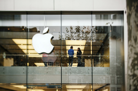 FRANKFURT AM MAIN, GERMANY - NOVEMBER 12, 2012: Apple Store logo and facade with Genius Employee explaining to a customer about the latest launched iPad Tablet.Apple is the world's largest publicly traded company wich sells consumer electronics and innovaのeditorial素材