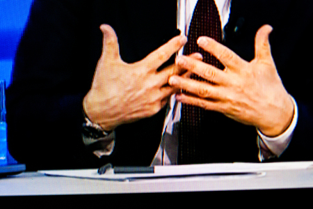 PARIS, FRANCE - APRIL 17, 2014: Russian President Vladimir Putin's hands at annual televised call-in with the nation as seen on a digital display. Putin urged dialogue between Russia and Ukraine on APR 17, 2014のeditorial素材