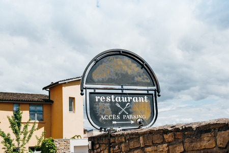 Luxury restaurant membership club sign showing fork and knife and directions to secure parking, Paris, Franceのeditorial素材
