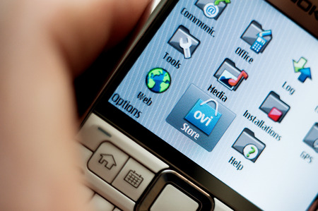 CUPERTINO, UNITED STATES - FEBRUARY 11, 2012: Ovi by Nokia as seen on a Nokia Smartphone display on February 11, 2012. Ovi the brand for Nokia's Internet services for games, maps, media, messaging and musicのeditorial素材