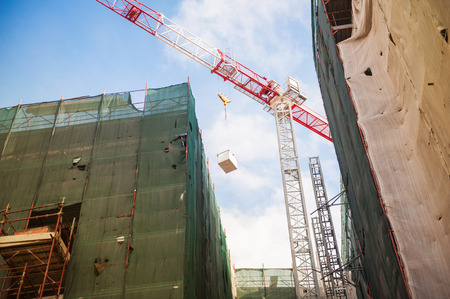 Reconstruction site with crane and protected buildings as seen from belowの写真素材