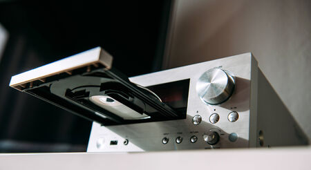 Modern Hi-Fi stereo amplifier tuner with CD tray open as seen from lateral low angleの写真素材