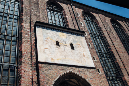 Sun clock - ancient vintage painted form on the facade of Munich Cathedral, Germanyの写真素材