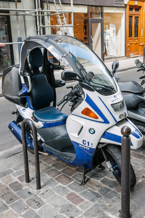 PARIS, FRANCE - AUGUST 18, 2014: BMW C1 200 scooter parked on a pedestrian area in a city street. BMW C1 is the rare enclosed scooter manufactured by Bertone for BMW and features most innovative design and emphasis on safety.のeditorial素材