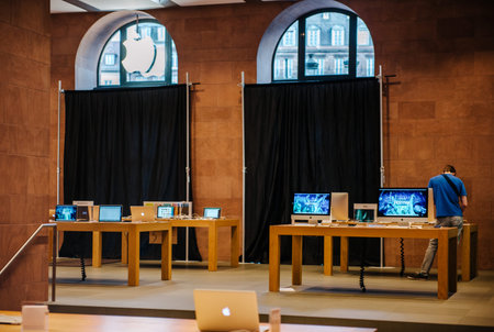 STRASBOURG, FRANCE - SEPTEMBER 18, 2014: Apple Store with working Apple Genius Employee and covered...