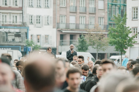 STRASBOURG, FRANCE - SEPTEMBER 19, 2014: Security guard looking above the crowd which stands in front of the Apple Store during the sales launch of the iPhone 6 and iPhone 6 Plus in Europe, on Friday, Sept. 19, 2014. Apple stores attracted long lines of fのeditorial素材