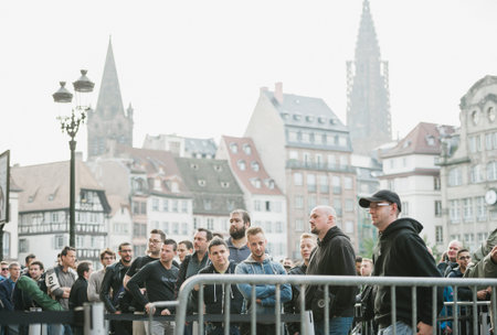 STRASBOURG, FRANCE - SEPTEMBER 19, 2014: Customers wait in line outside in front of the Apple Inc....