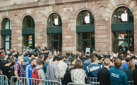 STRASBOURG, FRANCE - SEPTEMBER 19, 2014: Customers wait in line outside the Apple Inc. store during...