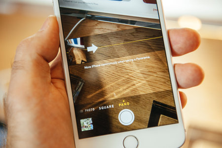 PARIS, FRANCE - SEPTEMBER 20, 2014: Hand holding a iPhone 6 Plus displaying the Camera app and Panorama Button during the sales launch of the latest Apple Inc. smartphones at the Apple store in Paris, Franceのeditorial素材