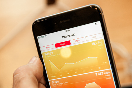 PARIS, FRANCE - SEPTEMBER 20, 2014: Hand holding a iPhone 6 Plus displaying the new Health App during the sales launch of the latest Apple Inc. smartphones at the Apple store in Paris, Franceのeditorial素材